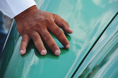 Cropped image of hand on vintage car