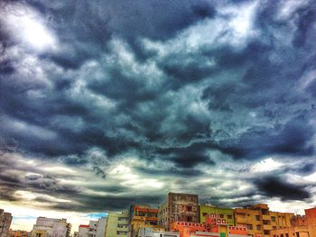 Buildings against cloudy sky