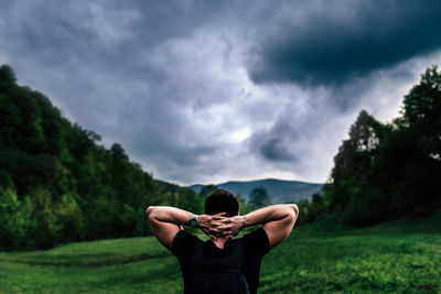 Rear view of man standing against sky