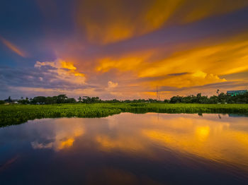 Scenic view of lake against sky during sunset