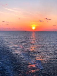 Scenic view of sea against romantic sky at sunset