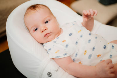 Portrait of cute baby lying down on bed