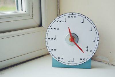 Close-up of musical clock on table