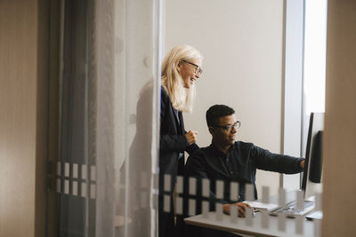 Coworkers talking in office