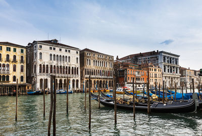 Boats in canal with buildings in background