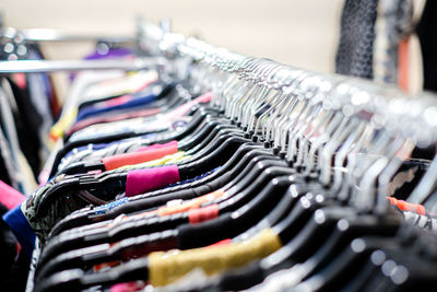Close-up of clothes on rack for sale in store