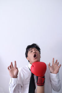 Portrait of young man against white background