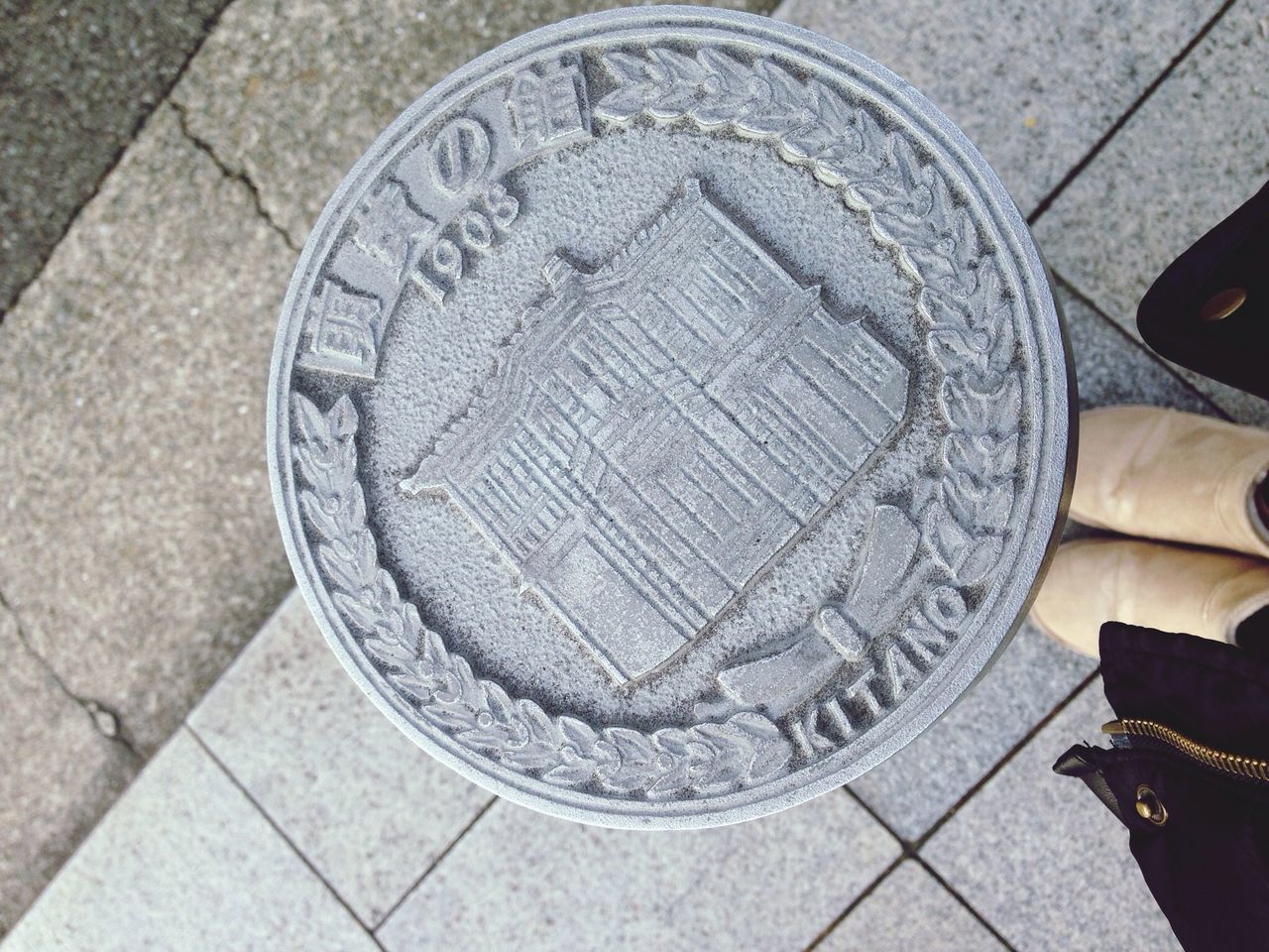 high angle view, circle, street, paving stone, still life, close-up, pattern, geometric shape, cobblestone, directly above, no people, outdoors, day, sidewalk, flooring, tiled floor, manhole, metal, pavement, shape