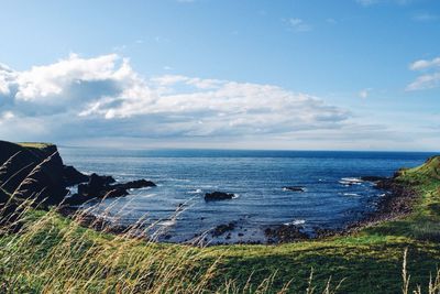 Scenic view of sea against cloudy sky