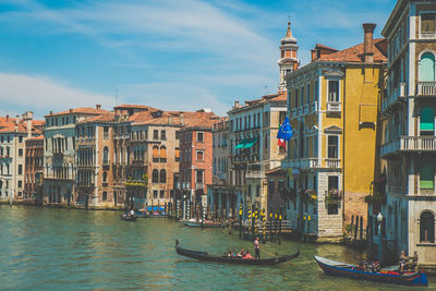 Boats in canal with buildings in background