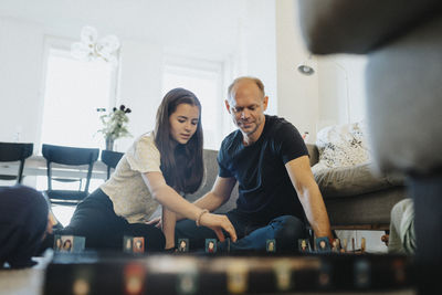 Father and daughter bonding over playing board games