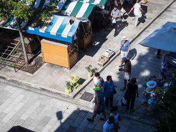 High angle view of people walking on footpath