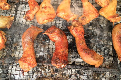 High angle view of chicken meat on barbecue grill