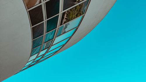 Low angle view of modern building against clear blue sky