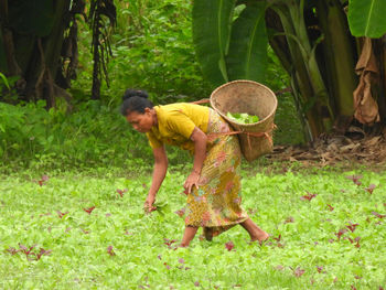Side view of woman standing in park