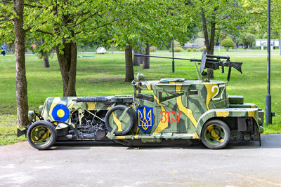 An armored car painted in camouflage with the coat of arms of ukraine under the emblem of ukraine