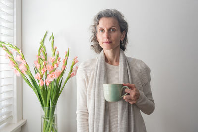 Portrait of smiling woman holding coffee cup