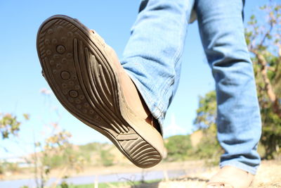 Low section of man walking on land