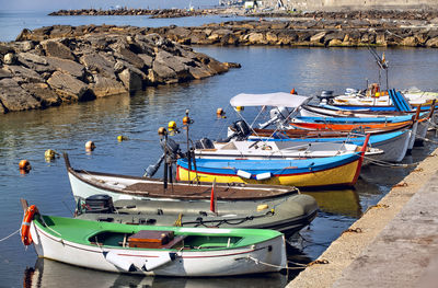 Boats moored on sea shore