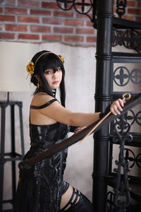 Young woman standing against railing