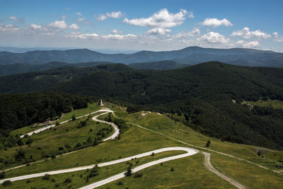 High angle view of green landscape against sky
