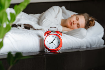 Portrait of young woman sleeping on bed