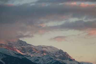 Scenic view of snowcapped mountains against sky during sunset