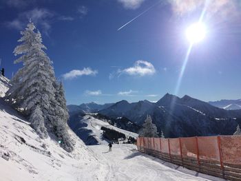 Scenic view of mountains against blue sky during winter