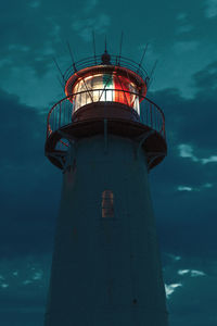 Low angle view of lighthouse against sky at night