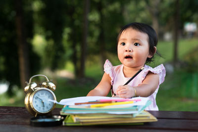 Close-up of girl studying at park