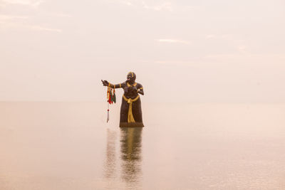 People on sea against sky