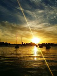 Sailboat in sea at sunset