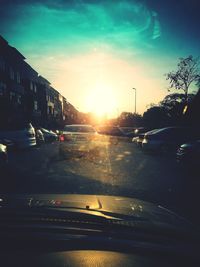 Traffic on road at sunset