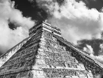 Low angle view of building against cloudy sky