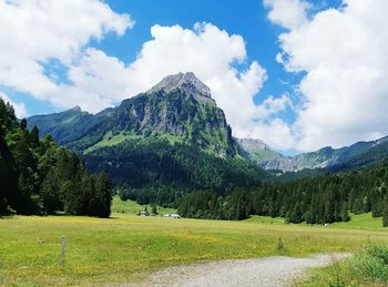 Scenic view of landscape and mountains against sky