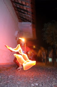 View of burning candle on fire at night