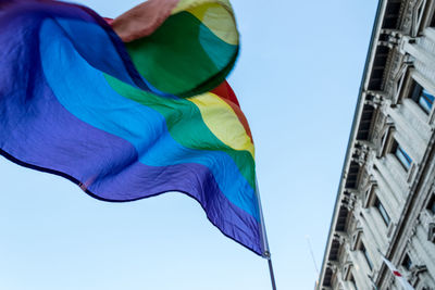 Low angle view of flags against clear blue sky