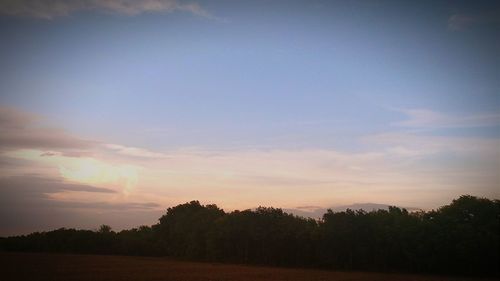 Scenic view of landscape against sky at sunset