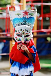 Person wearing mask while standing at park