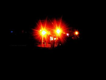 Silhouette people against sky at night