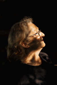 Portrait of elderly woman in glasses close-up on natural background. profile of man 