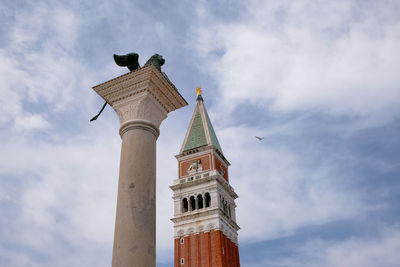 Low angle view of tower of building against cloudy sky