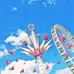 Low angle view of ferris wheel against blue sky