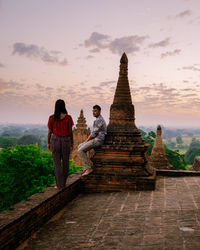 Tourists at temple against building