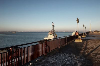 Pier on sea against clear sky