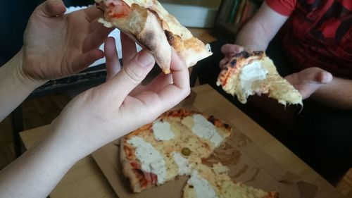 People eating pizza at home