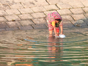 Full length of woman standing in water