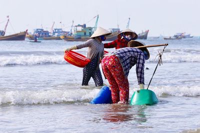 People on beach against sky