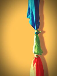 Close-up of multi colored umbrella against wall