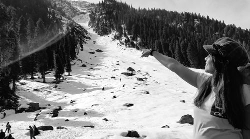Rear view of person on snow covered land